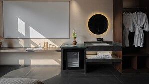 A modern bathroom with a large mirror, two sinks, a vanity, and a robe rack. - Jinghong Chen Duo Nan Shan Man Zhen (Xishuangbanna Dai)