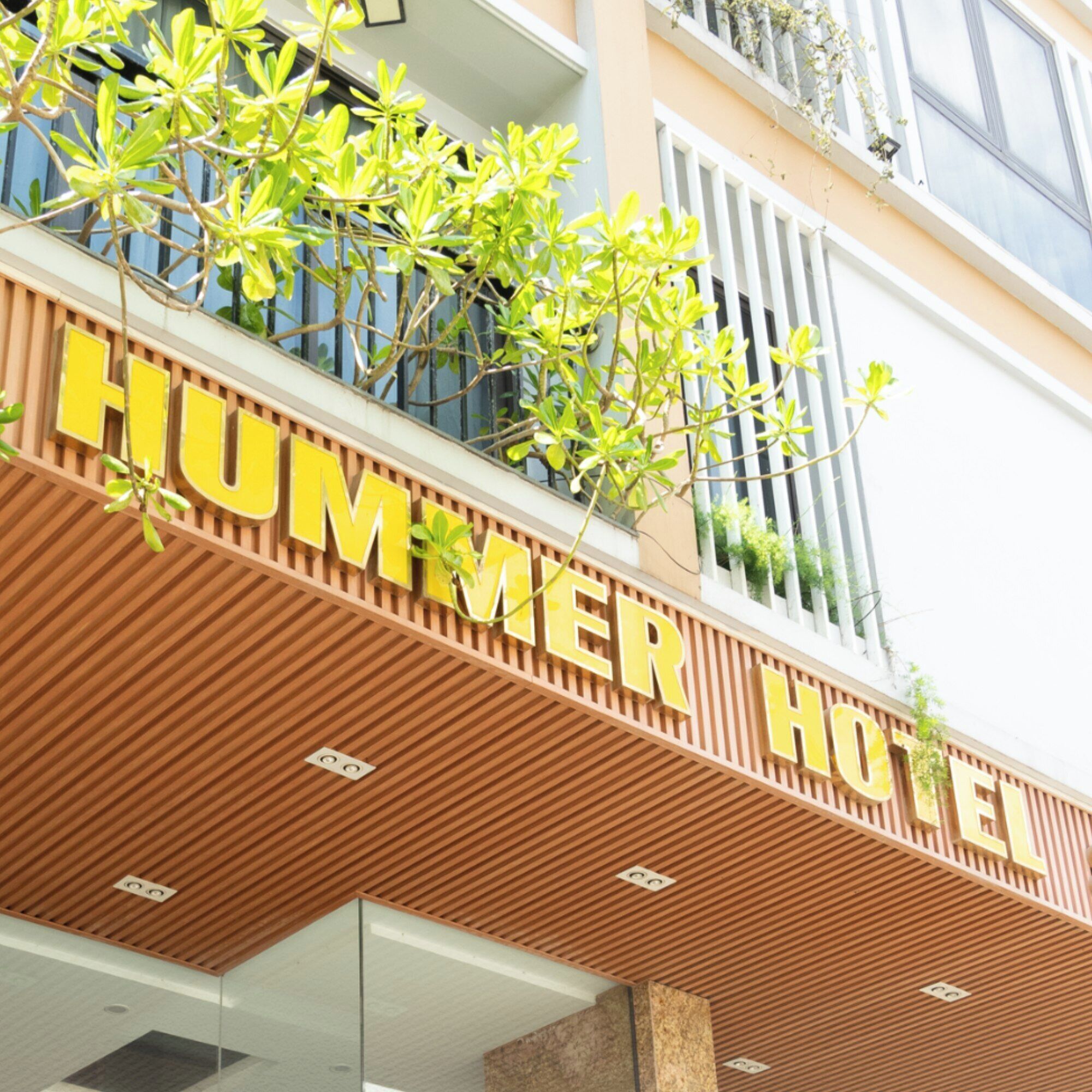 A hotel sign with the name 'HUMMER HOTEL' in large yellow letters.