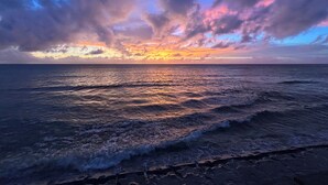 A beach with waves and a sunset. - The FLOW Okinawa (Chatan)