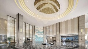 A spacious lobby with a circular marble floor, a central sculpture, and a large mural on the wall. - Jinke Grand Hotel Chongqing (Chongqing)