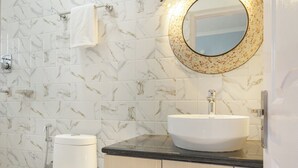 A bathroom with a toilet, sink, and vanity.
