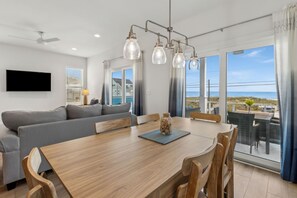 Relax in this inviting living area with a dining table, sofa, and flat-screen TV.
