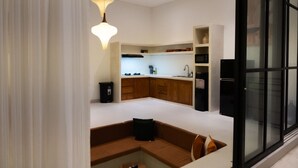 A modern kitchen with wooden cabinets, a built-in microwave, and a black refrigerator. - Azure Luxe Private Pool Villa, 6min PererenanBeach (Pererenan)