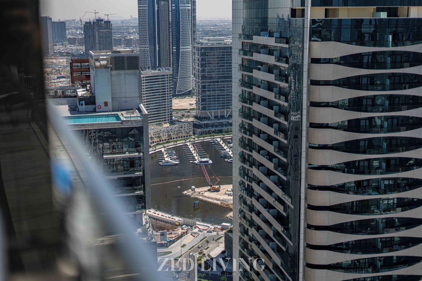 A high-rise building with a modern design, featuring a curved facade and multiple balconies.