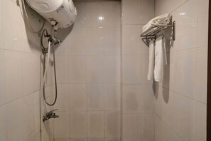 A shower area with a handheld showerhead, a towel rack with towels, and a wall-mounted hairdryer. - Zhenghong Hostel (Shanghai)