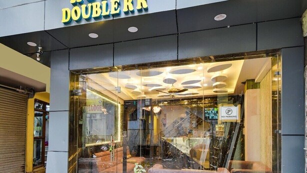 A hotel entrance with a glass facade, a 'No Parking' sign, and a 'Welcome' sign. - Hotel Double Rr Newly Renovated  (New Delhi)