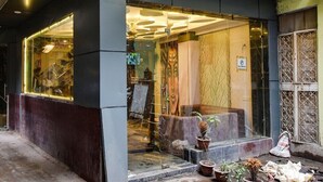 A storefront with a glass facade, a sign reading "DOUBLE R", and potted plants outside. - Hotel Double Rr Newly Renovated  (New Delhi)