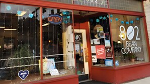 A storefront with a 'OPEN' sign, a heart-shaped sticker, and a 'Bean Company' sign. - Pittsburgh #GoadLife - Local Art - Family/Dog/Business Friendly - Patio BBQ (Pittsburgh)