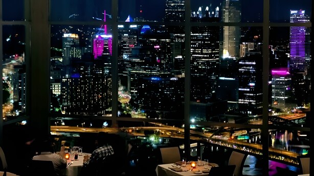 A restaurant with a city view at night, featuring illuminated buildings and a bridge. - Pittsburgh #GoadLife - Local Art - Family/Dog/Business Friendly - Patio BBQ (Pittsburgh)