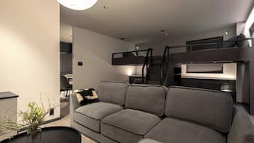 Family Quadruple Room | Living area | 62-inch Smart TV with digital channels