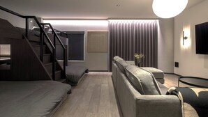 Une chambre moderne équipée d’un lit superposé, d’un canapé, d’une petite table et d’un téléviseur.
