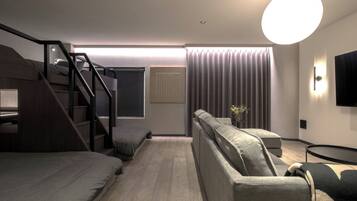 Family Quadruple Room | Living area | 62-inch Smart TV with digital channels