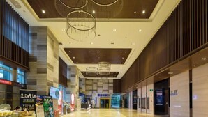A spacious corridor with a modern ceiling design, a clear view of the entrance, and a signboard advertising a VIP service. - Tuyu Boutique Apartment (Chengdu)