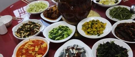 A table with various dishes and a large pot, likely for a communal meal.