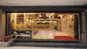 Der Eingang von HOTEL THE PARAMOUNT mit Glasfassade, rotem Teppich und Marmorboden.