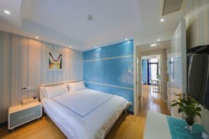 Ett modernt hotellrum med en stor säng, ett nattduksbord, en TV och utsikt över korridoren.