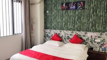 A hotel room with a bed, a window with blinds, a wall with a bamboo pattern, and a wall with a mosaic design.