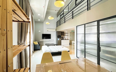 Deluxe Duplex, City View | Living area | Flat-screen TV