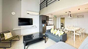 Deluxe Duplex, City View | Living area | 45-inch Smart TV with digital channels