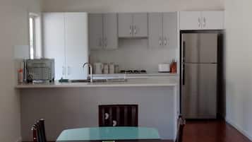 Fridge, stovetop, cookware/dishes/utensils, dining tables