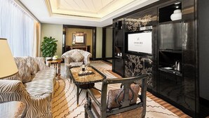 A luxurious hotel lobby with a zebra-patterned sofa, a coffee table with a bottle, a decorative cabinet, and a large mirror. - Renhe Spring Hotel (Chengdu)
