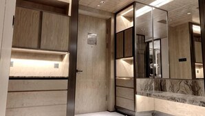 A modern elevator with wooden paneling and a marble accent wall. - Shanghai Grand Hotel (Shanghai)