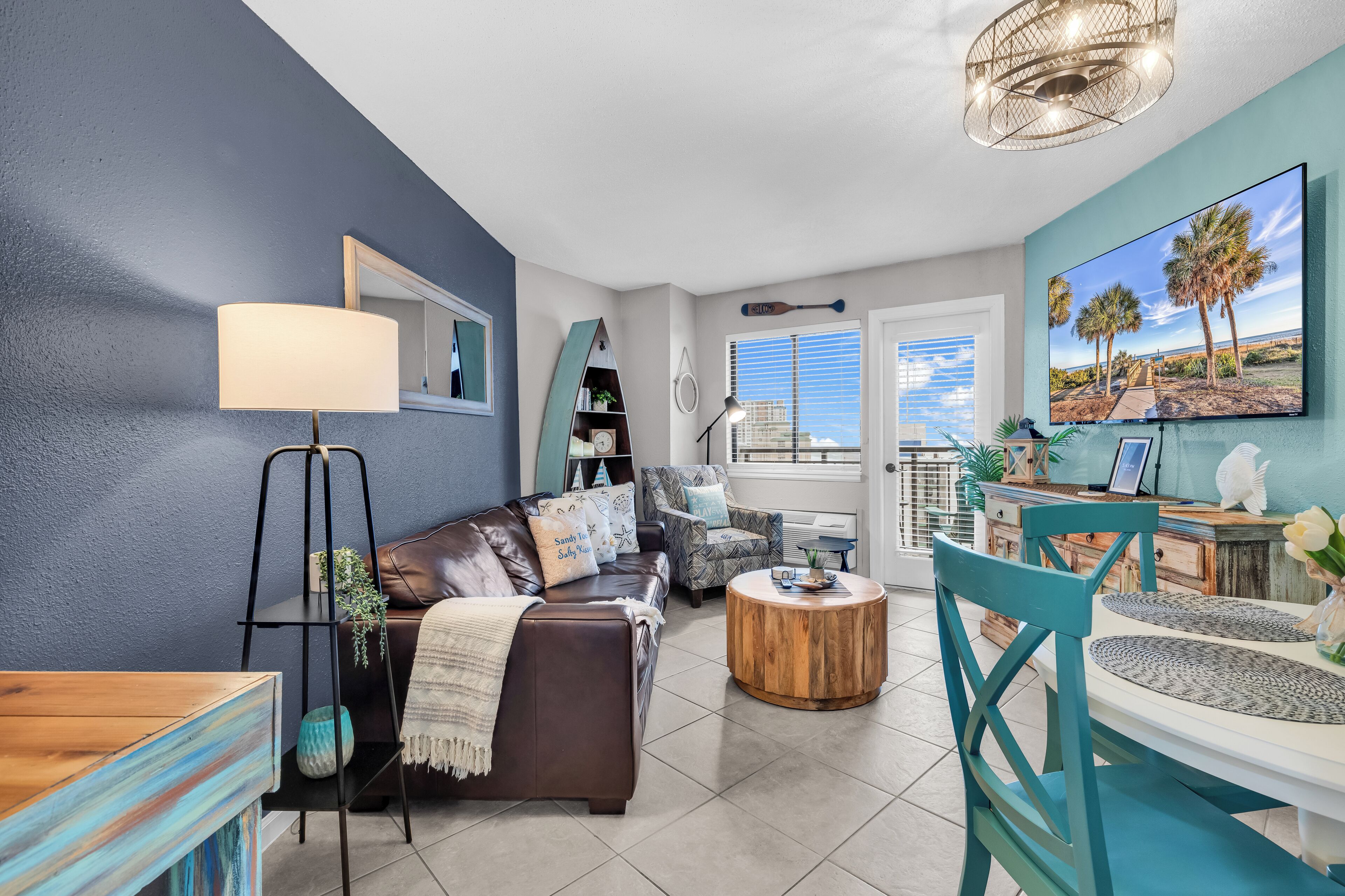 Signature Condo, 1 Bedroom, City View, Beachfront | Living room | 65-inch Smart TV with digital channels, books