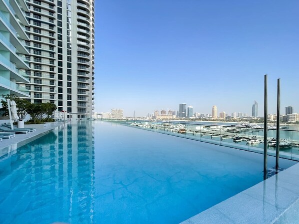 Enjoy breathtaking views of the marina and city skyline from our rooftop infinity pool.