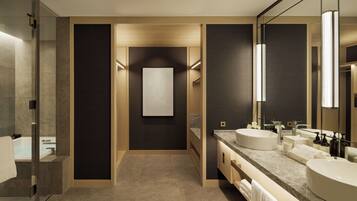 A modern bathroom with a glass shower, two sinks, a large mirror, and a neutral color scheme.