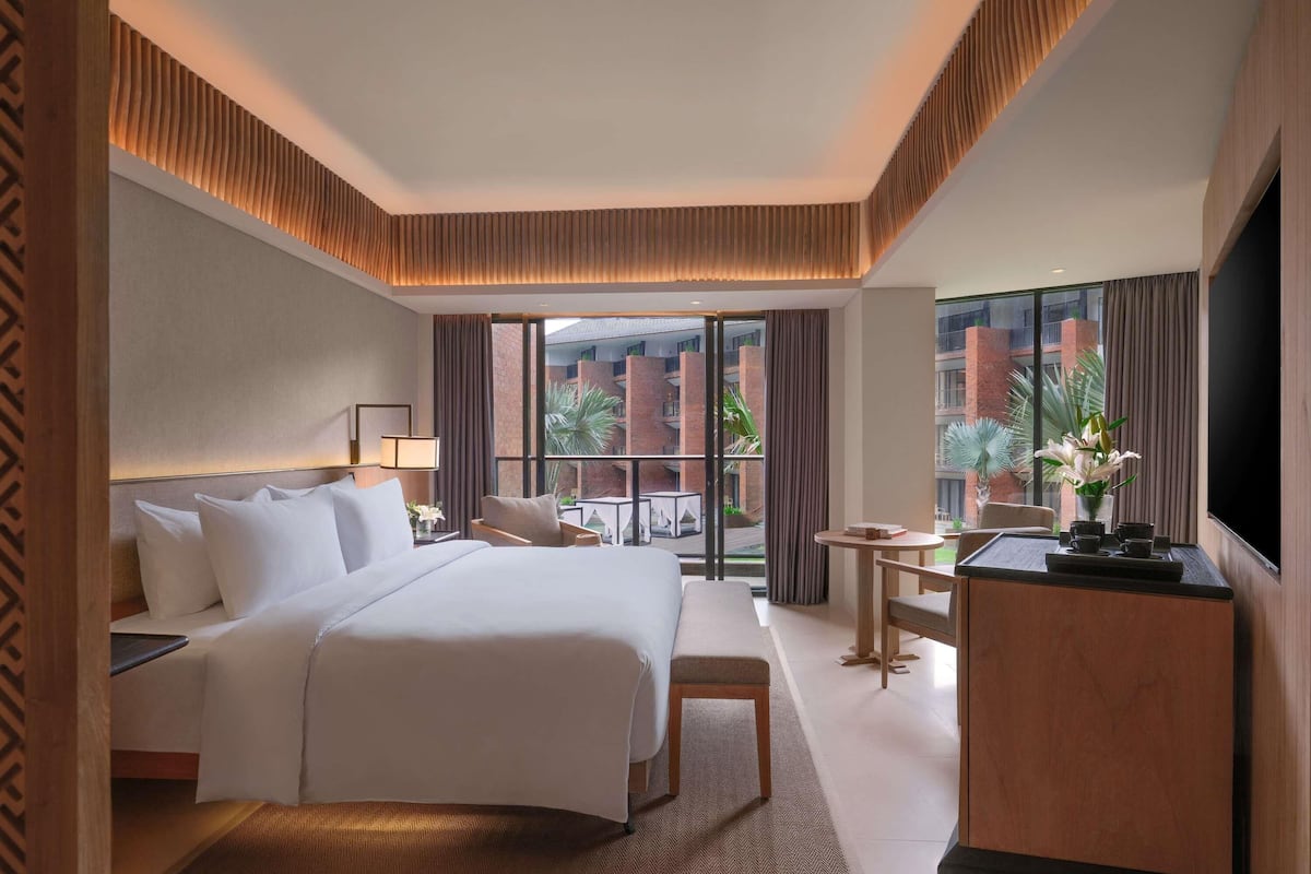 Grand Deluxe room, balcony and pool view - 1 king bed | In-room safe, desk, blackout curtains, soundproofing