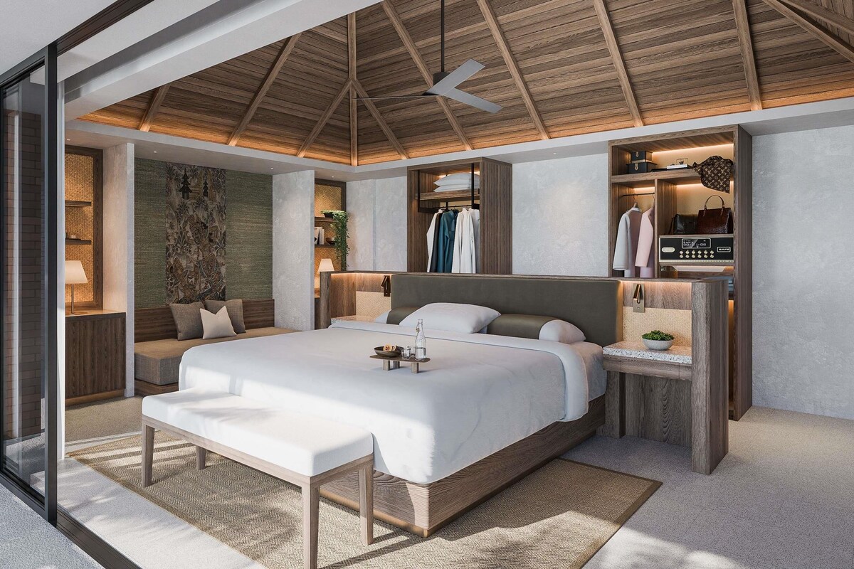 A modern bedroom with a large bed, a bedside table, a wardrobe, and a ceiling fan.