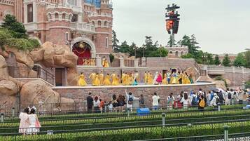 A castle-like building with a balcony and a crowd of people.
