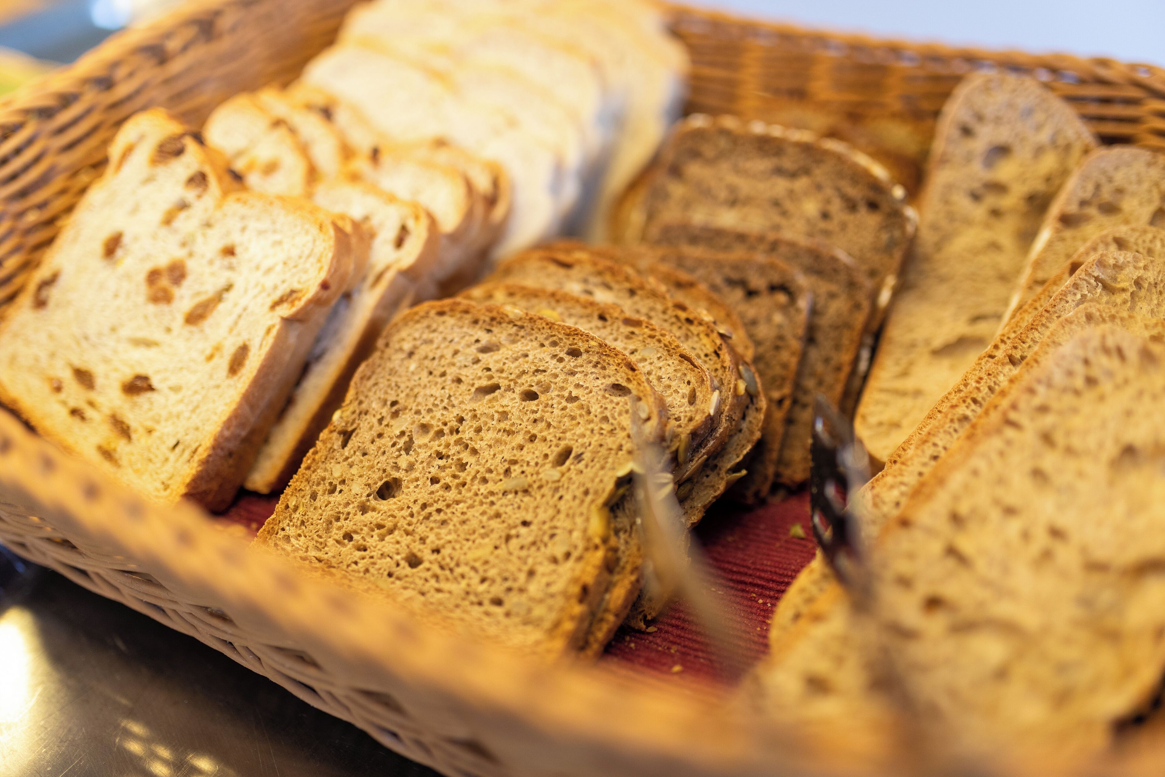 A basket of sliced bread on a table.