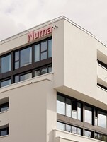 A modern building with a prominent 'Numa' sign on the top.