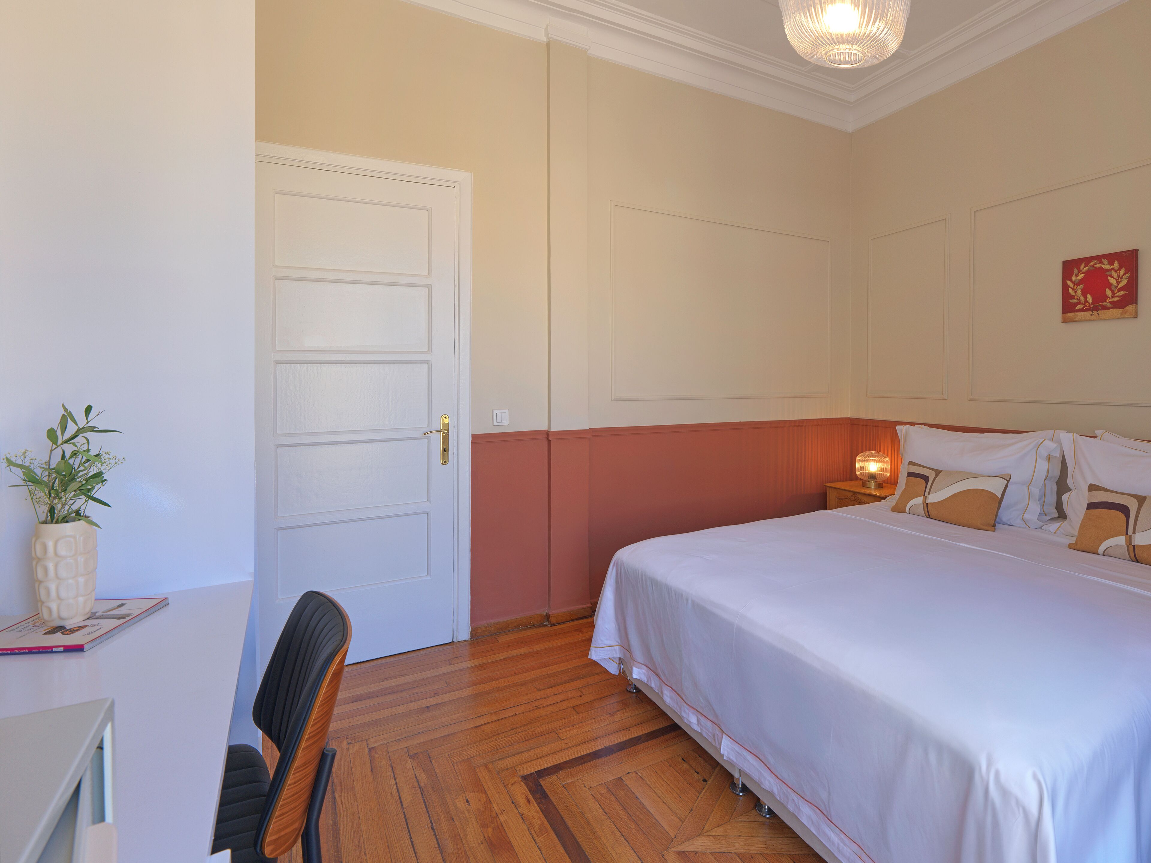 Un dormitorio con una cama, un escritorio y una silla.
