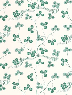 A pattern of clover-like shapes and fern-like leaves on a plain background.