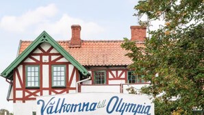 Un bâtiment traditionnel sur lequel on peut lire l’inscription : « Bienvenue à Olympia ».