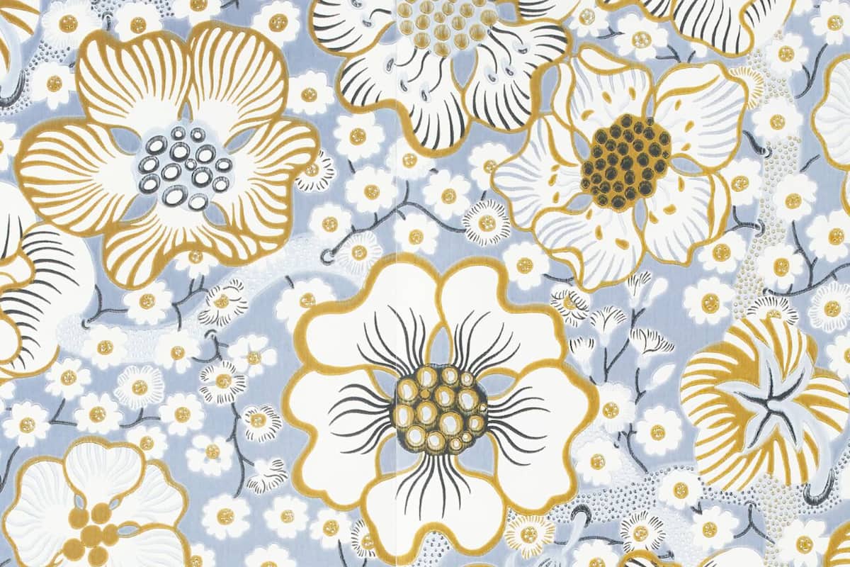 A pattern of stylized flowers and leaves on a fabric.