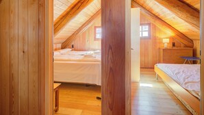 A wooden attic bedroom with two beds, a desk, and a window. - Rustico Al Museo Bosco Gurin for 6 (Bosco Gurin)