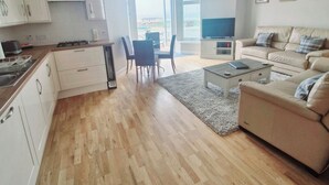 A modern apartment with a kitchen, dining area, and living room. - The Beaches, beachfront 2 bed home with seaviews in Banff Aberdeenshire (Banff)