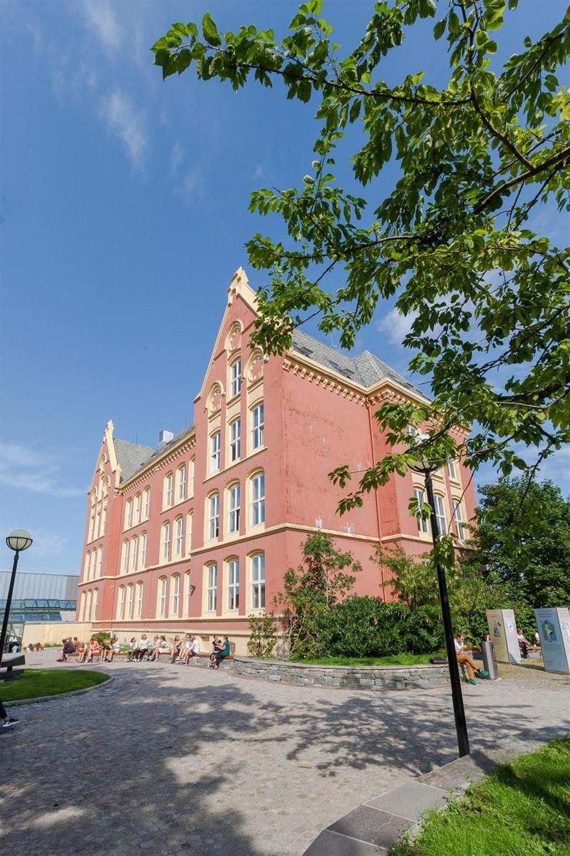 A large red building with multiple windows and a prominent entrance.