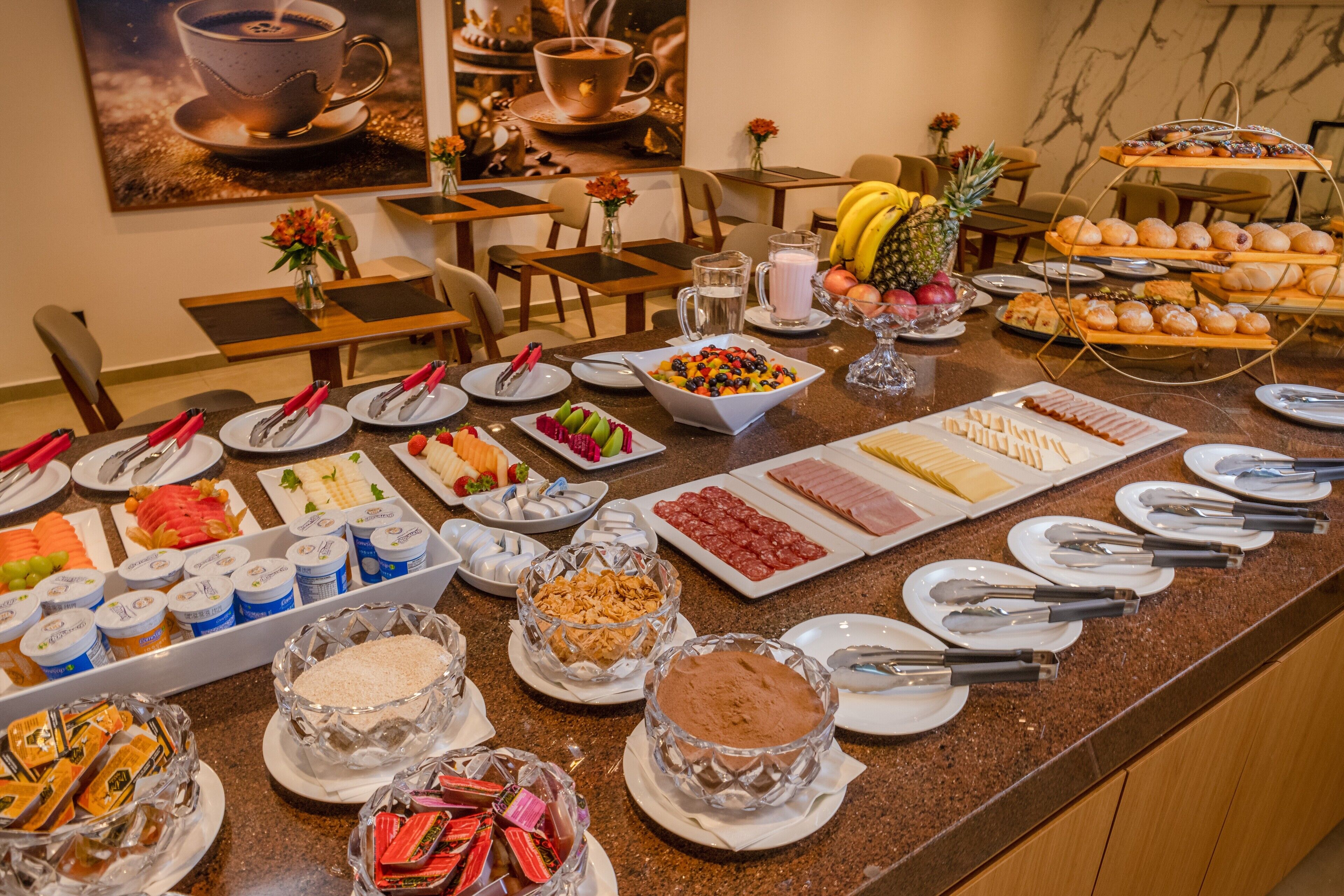 A buffet with various food items and utensils.