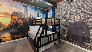 A bunk bed in a room with a brick wall and a mural of a castle. - 295 Marcello Blvd (Kissimmee)