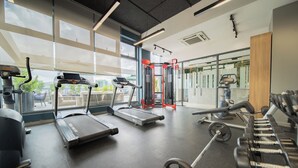A gym with treadmills, a weight bench, and free weights. - Loft Hotel Apartment (Addis Ababa)