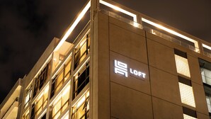 A modern building with illuminated signage for "LOFT Hotel Apartment." - Loft Hotel Apartment (Addis Ababa)