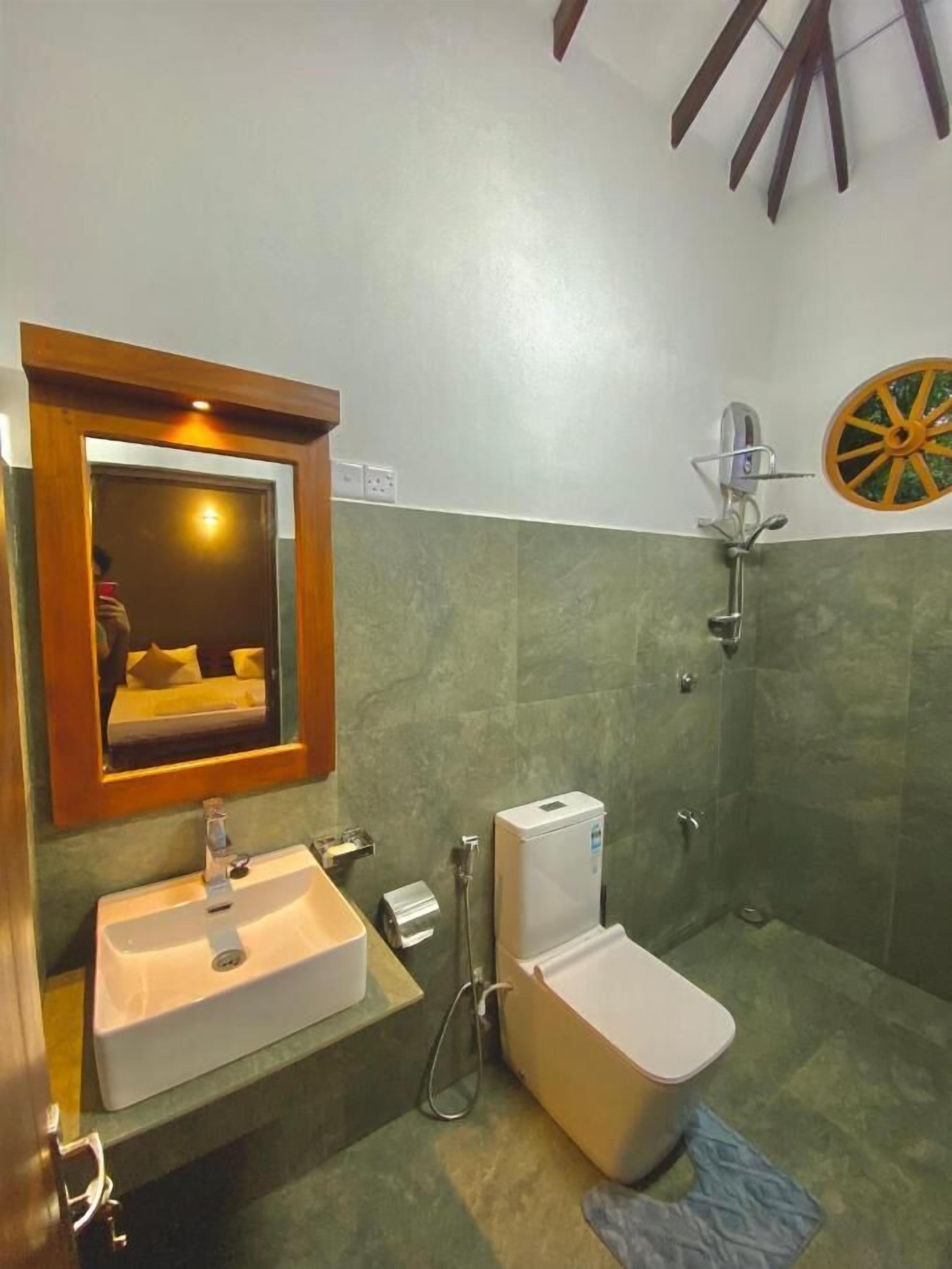 A bathroom with a sink, toilet, and shower.