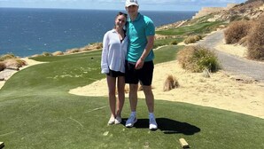 A couple standing on a golf course with a view of the ocean. - Vicroy Novaispania Estates (Cabo San Lucas)