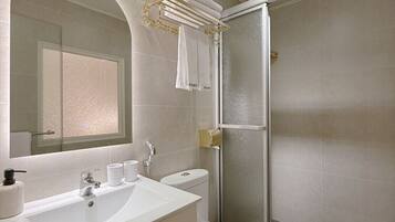A modern bathroom with a sink, toilet, and shower.