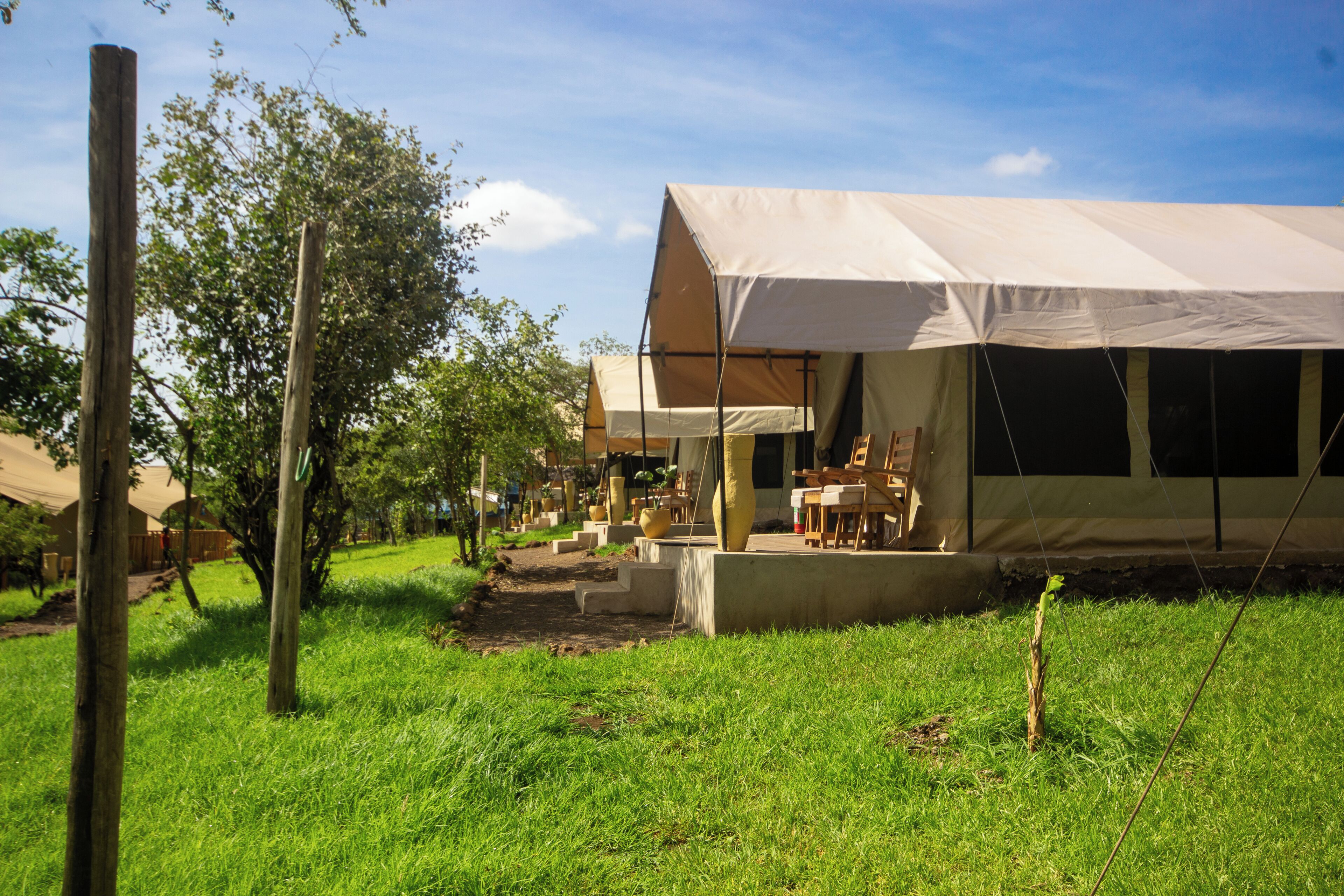 A campsite with tents and a dining area.
