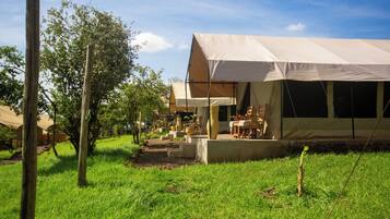 A campsite with tents and a dining area.